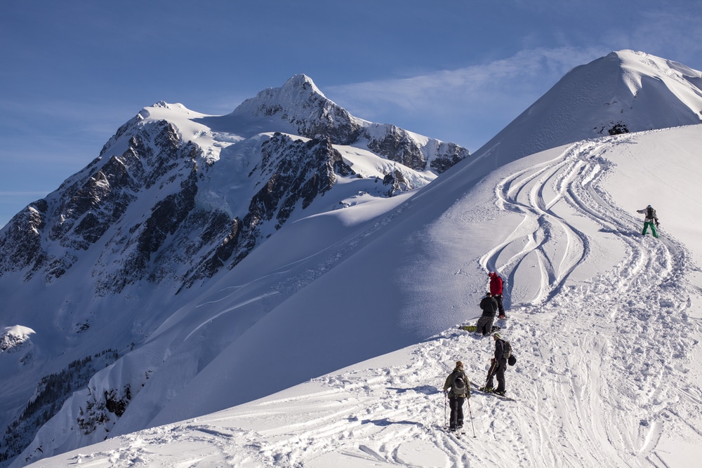 Mount Baker Ski Area, snowy mountain with skiers heading up on a sunny day