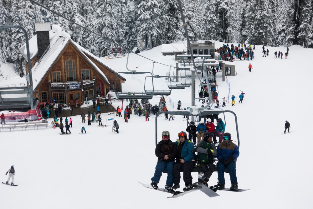 Mount Baker Ski Area, four skiers heading up the mountain on a lift 