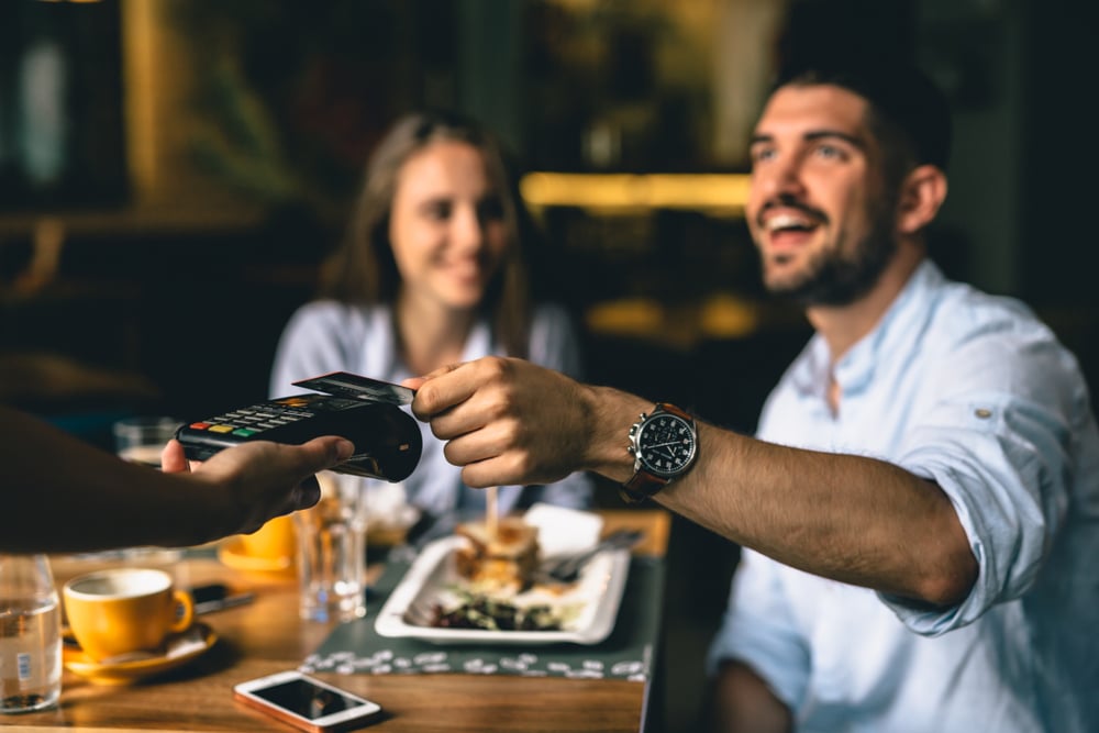 Man paying after a dinner at one of the top restaurants in Bellingham